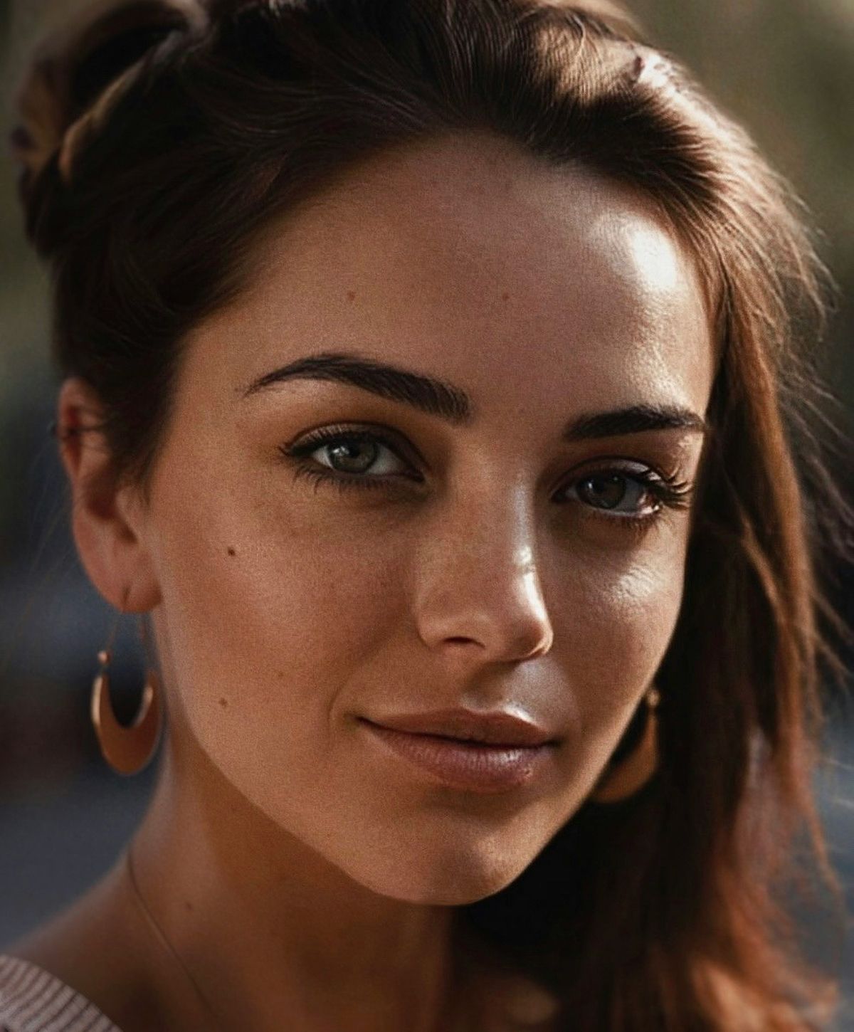 Close-up of a thoughtful woman embracing her knees.