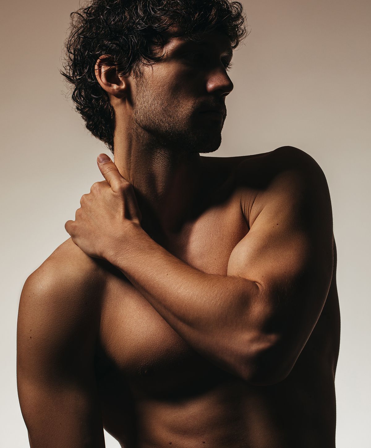 Male model posing with artistic lighting.