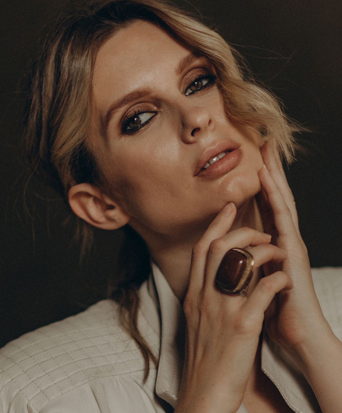Portrait of a woman with stylish makeup and accessories.