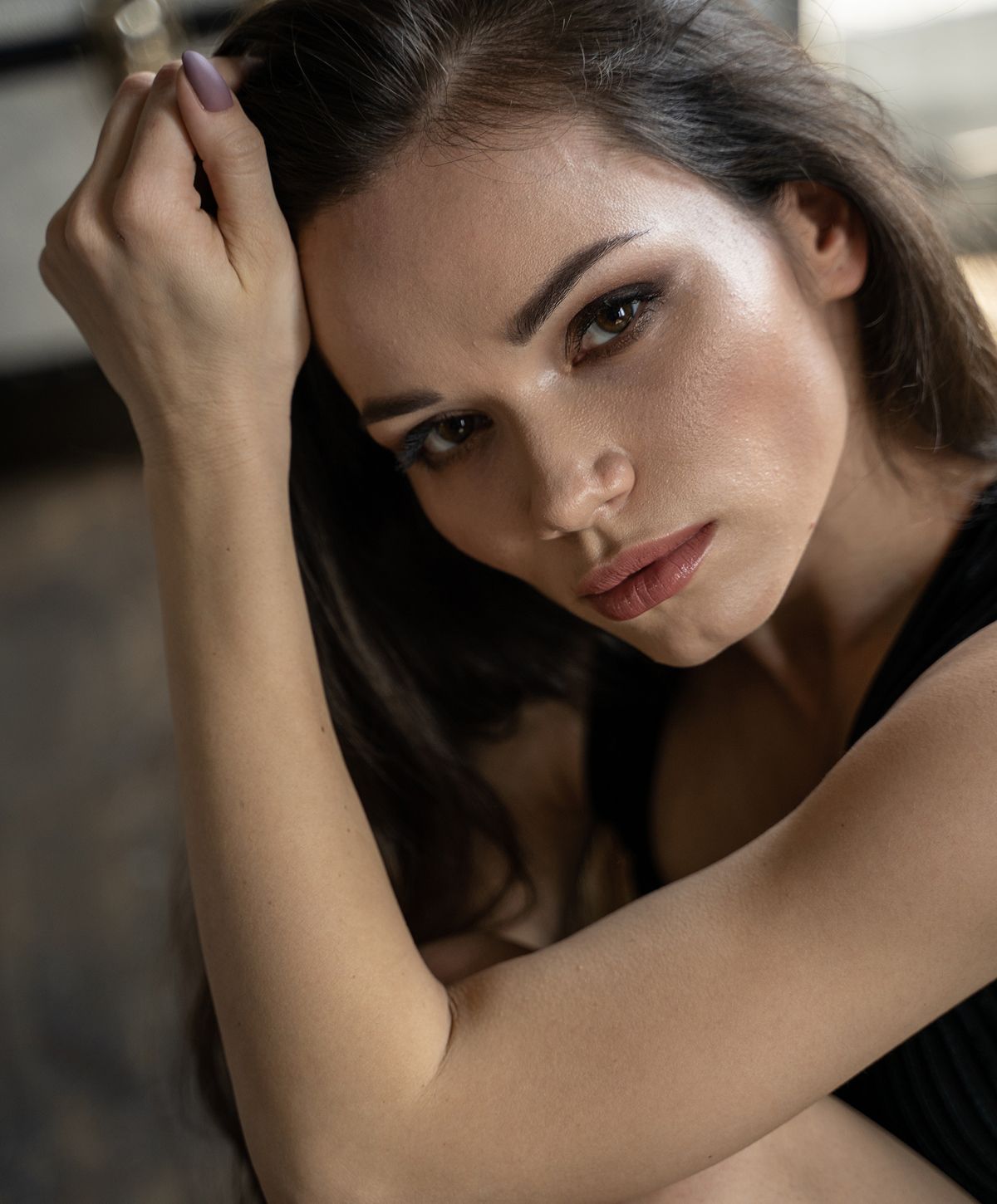 Close-up of a contemplative woman with long hair.
