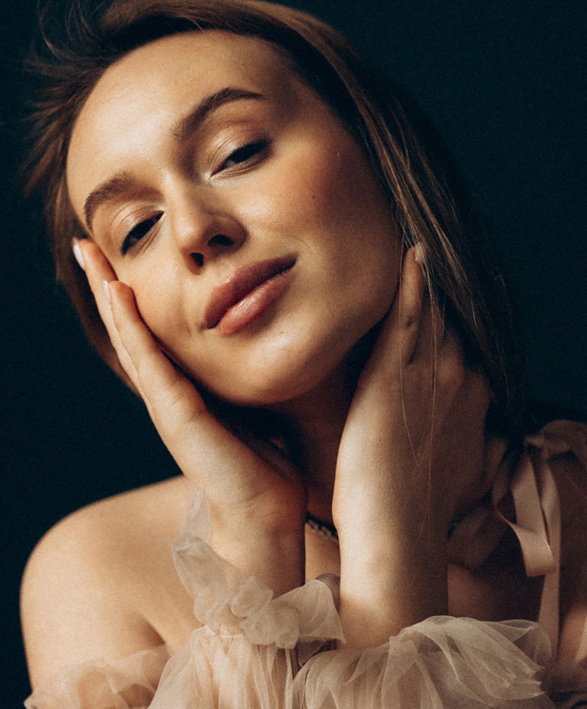 Woman with red hair and soft expression.