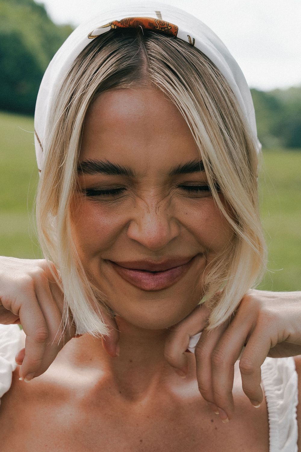 Woman with closed eyes and elegant jewelry.