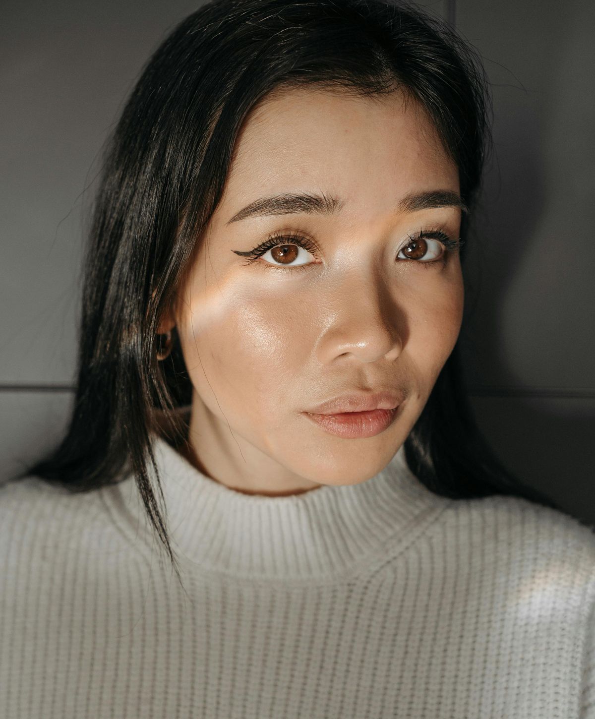 Woman with long hair and natural makeup.