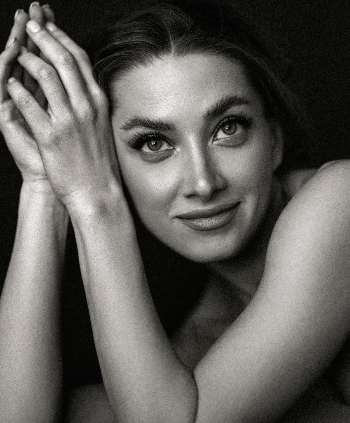 Black and white portrait of smiling woman.