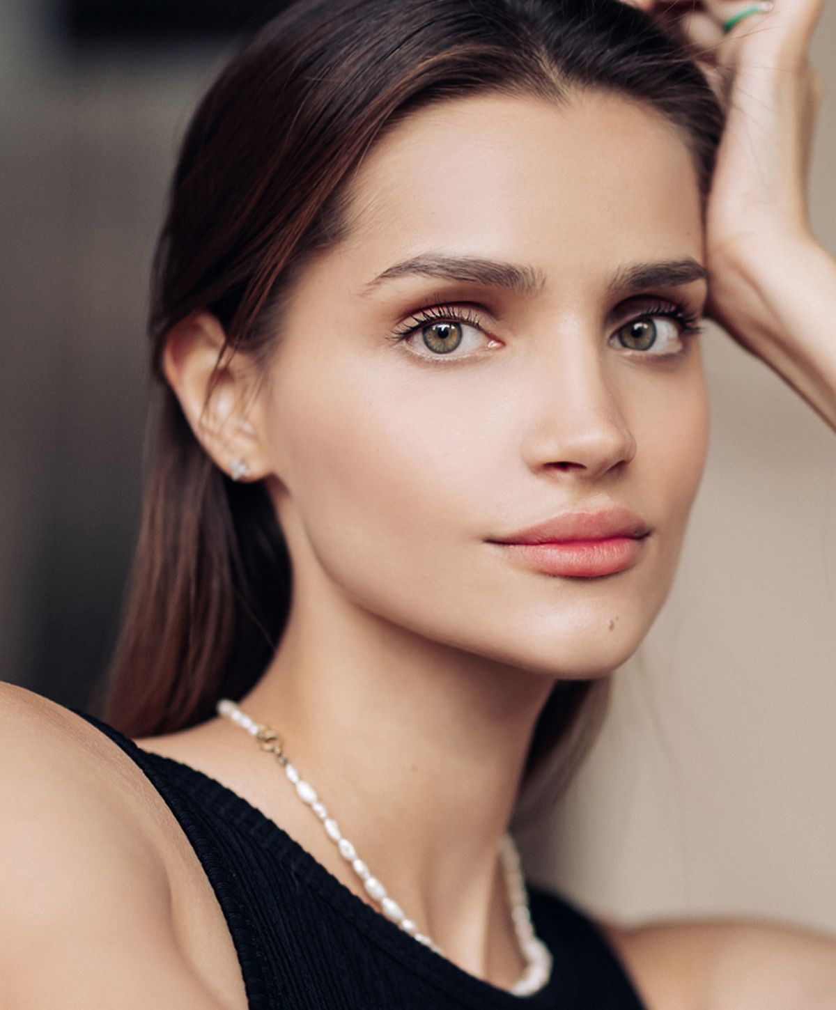 Young woman with long hair and subtle makeup.