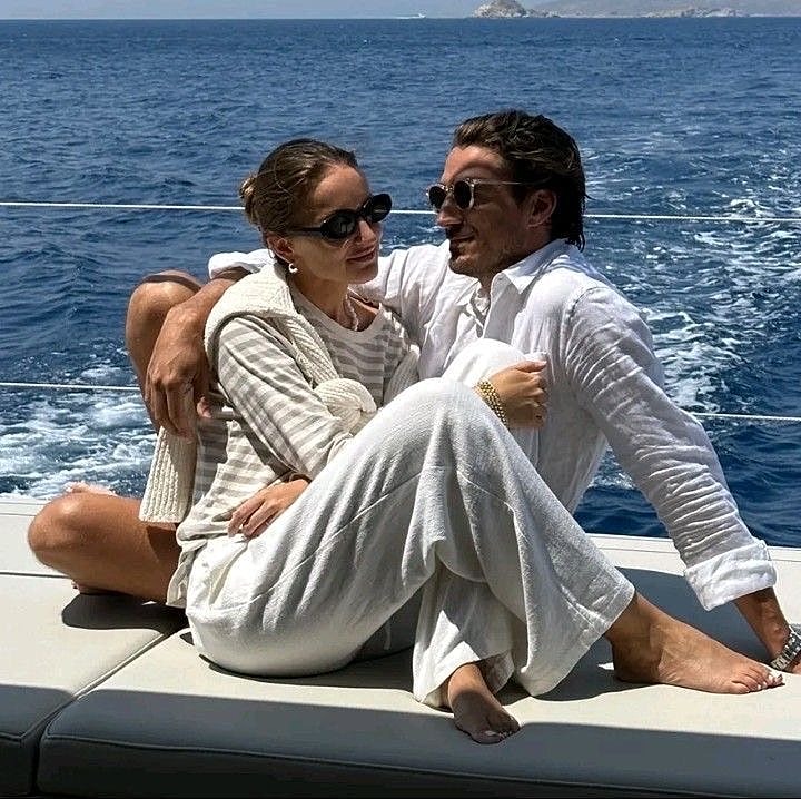 Couple enjoying a romantic moment on a yacht.