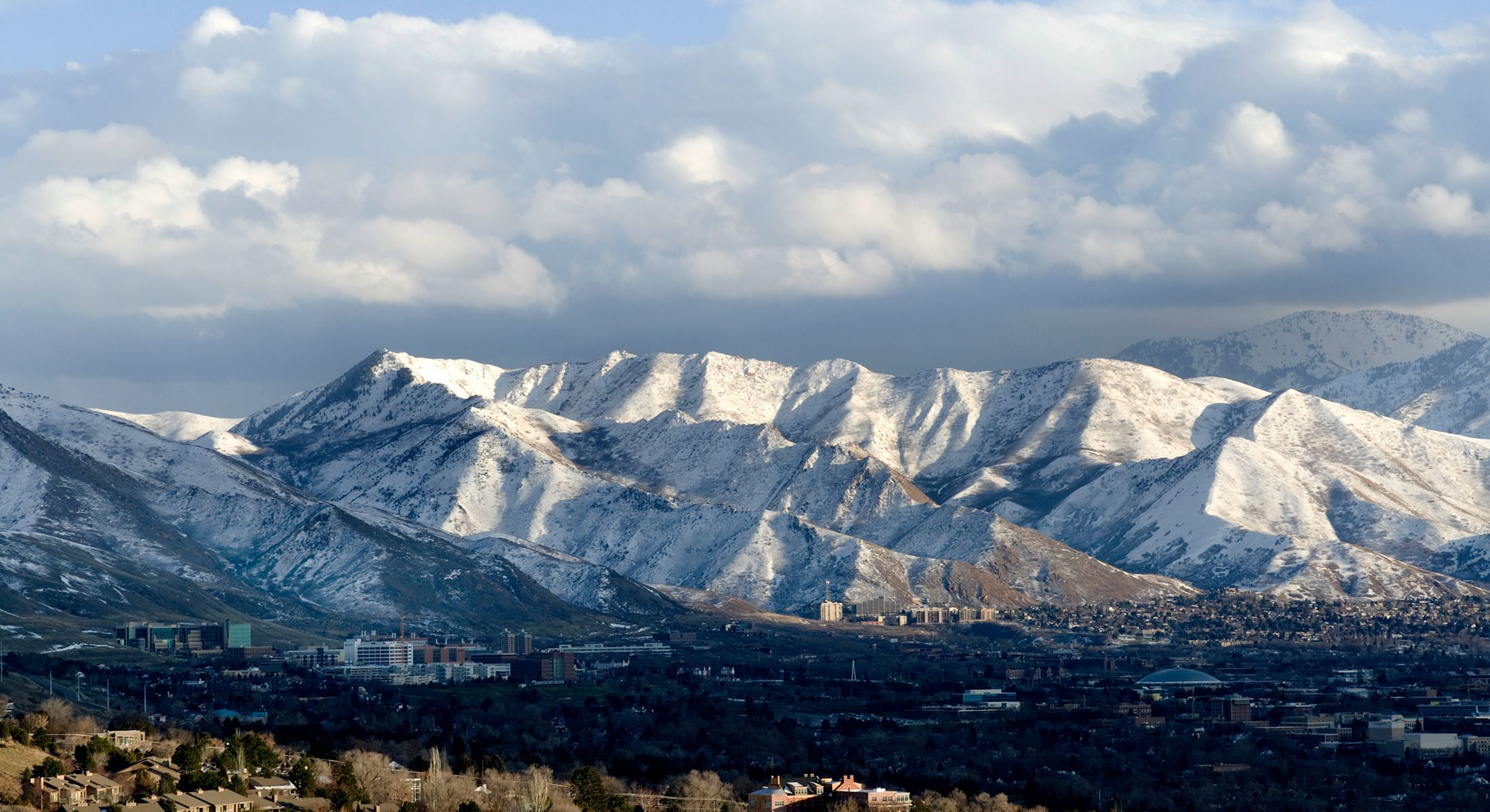 Snow-capped mountains under a cloudy sky.