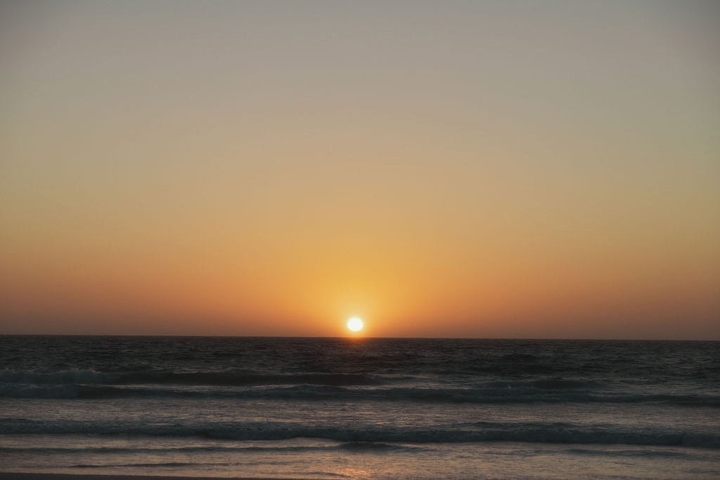 Snow-capped mountains under dramatic cloudy sky