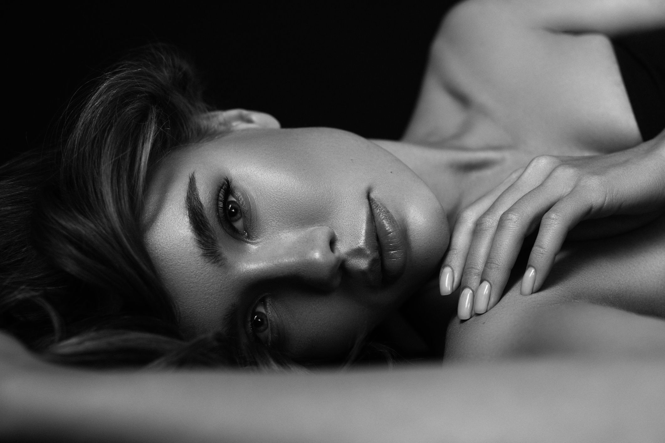 Woman in beige coat lost in thought.