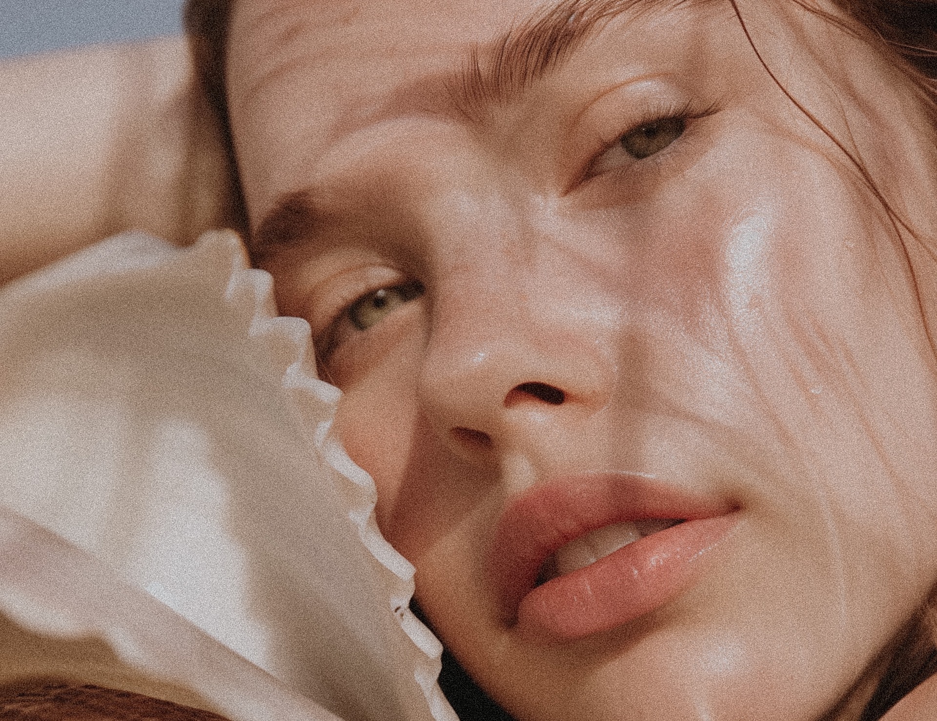 Elegant woman with dramatic makeup and jewelry.