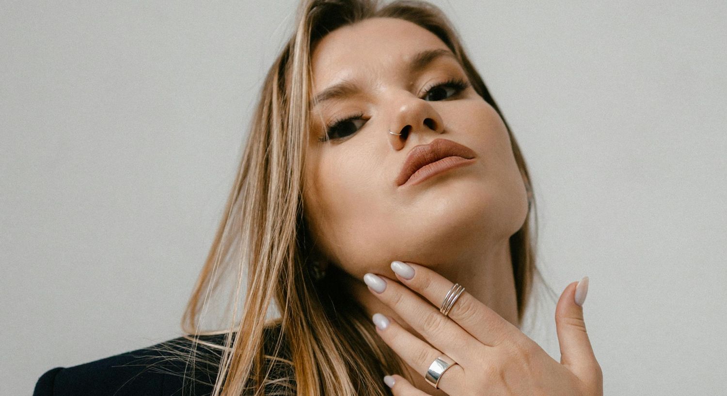 Woman with stylish jewelry and elegant pose.