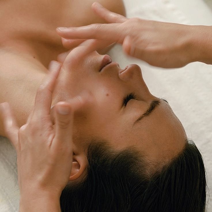 Person receiving a relaxing facial massage session.